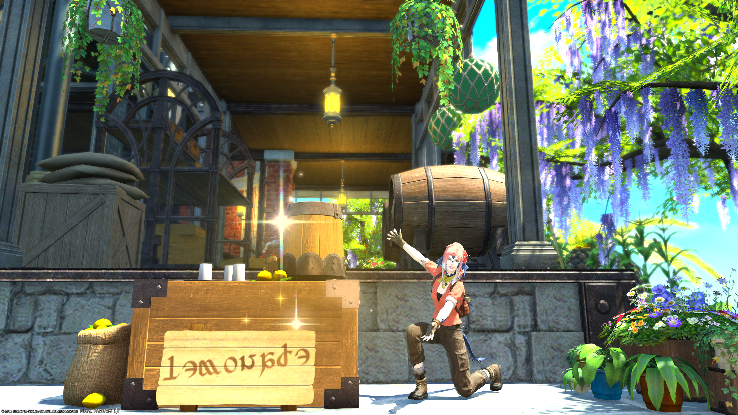 A screenshot from FFXIV. It depicts a character showing off a lemonade stand in front of a what appears to be an open air storage facility.