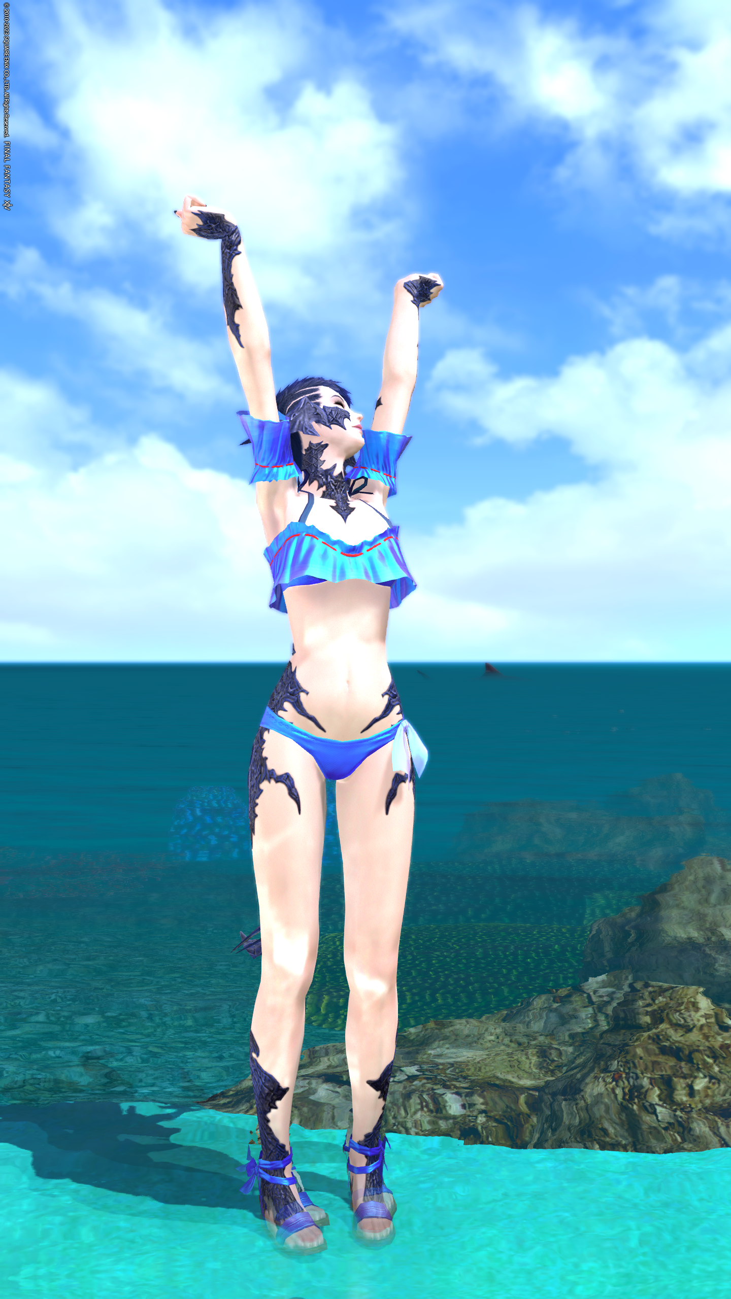 An image of an Au Ra from FFXIV. She is wearing a blue bathing suit and standing in front of the ocean while stretching. A shark looms in the water behind her.